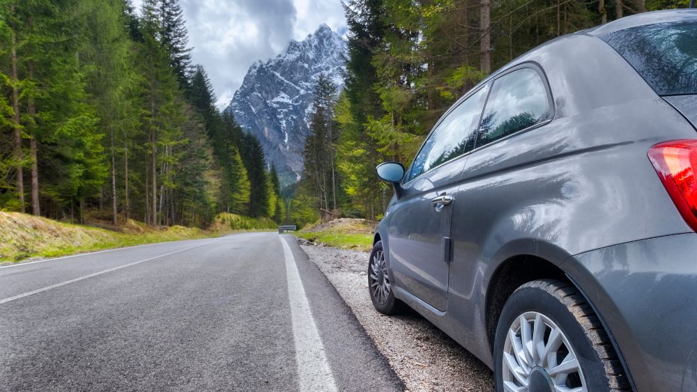 Mountain road with car or taxi